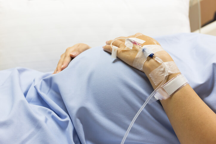 Pregnant woman in hospital bed