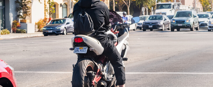 Young motorcycle rider waiting at an intersection to turn left