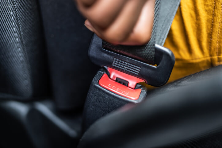 Person putting on seat belt