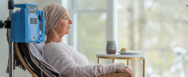 Female cancer patient sitting with monitor