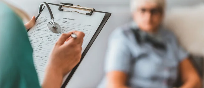 Dcotor reviews a patients chart
