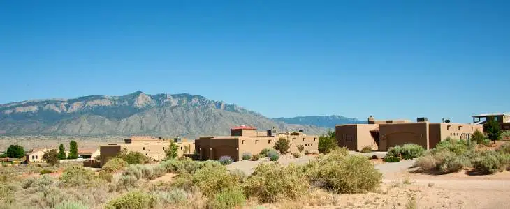 Scenic view of a town in Rio Rancho, with mountain ranges in the background